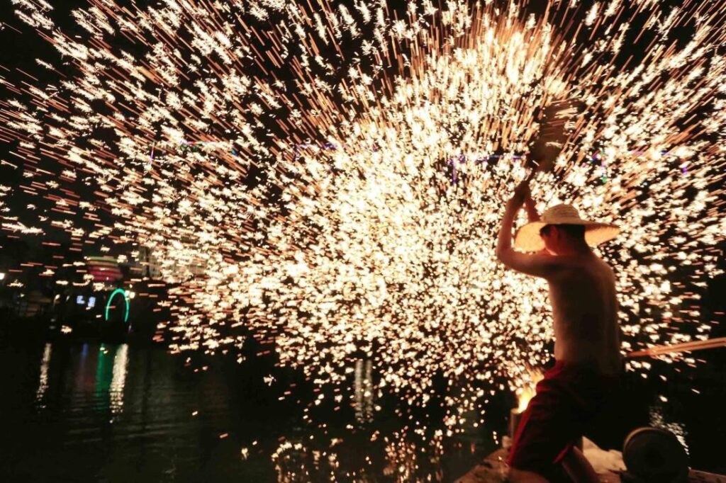 Iron fireworks 打铁花, molten metal struck into the air to fall as sparks