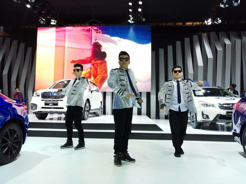 Performers mid-routine on the Subaru stand at a Chinese auto show